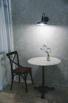 white garnite table with chair and vase