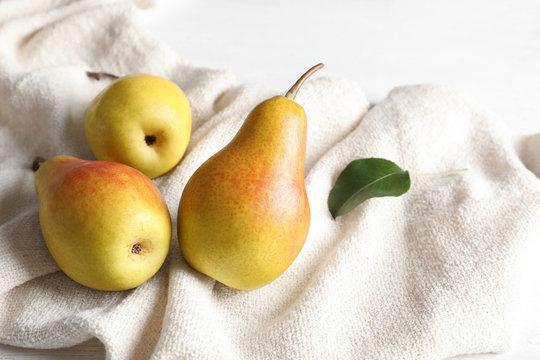 Ripe pears on light fabric. Healthy snack