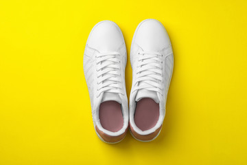Pair of sneakers on color background, flat lay