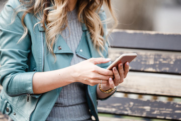 beautiful girl using phone on the street