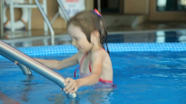 Little girl in public swimming pool
