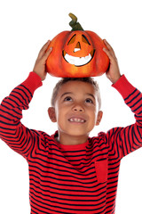 Happy latin boy holding a big pumpkin