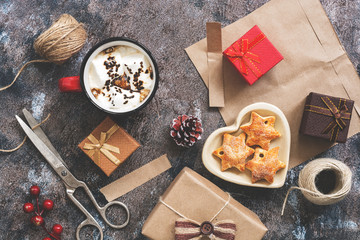 Making gifts for Christmas, paper, scissors, thread, hot chocolate, cookies on a rustic background. The concept of a holiday. Christmas. Top view.