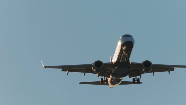 Close-up shot of a large airliner approaching the airport moments before landing on a bright sunny day