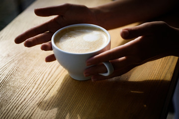 barista propose americano or espresso coffee cup. fresh morning coffee with milk and cream froth. Good start of the morning. perfect morning with best coffee. relax in cafe or coffee shop and drink