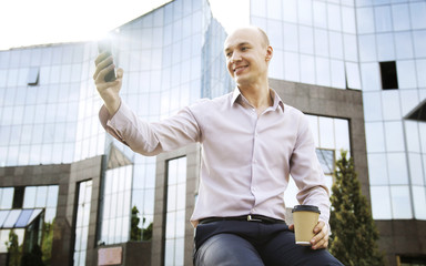 Businessman taking a picture of himself.