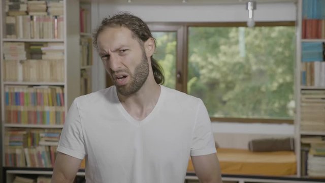 Millennial bearded man looking indifferent saying and gesturing whatever bad attitude and disinterest concept