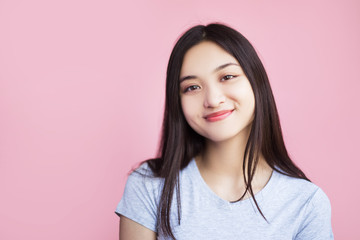 Fototapeta premium Smiling woman with dark straight hair, closed eyes and smiley face. She's happy and funny girl, she like to laugh and having fun. 