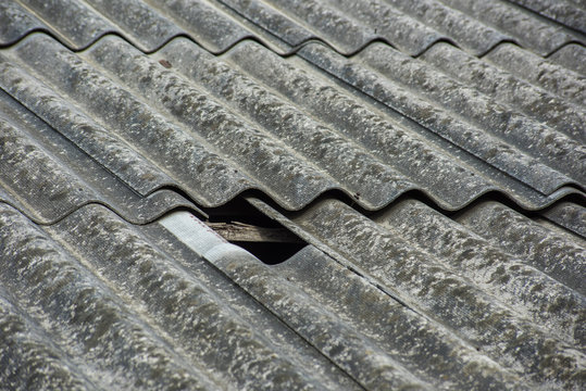 Slate texture on the roof with a broken hole