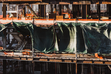 Green tarps at construction site floor