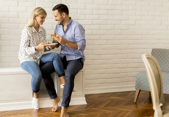 Lovely young couple eating pizza