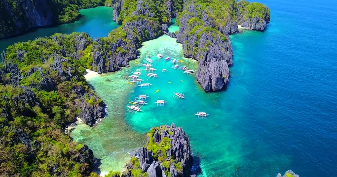Overhead View of Multiple Catamaran Style Boats Moored in Tropical Cove - El Nido, Palawan, Philippines