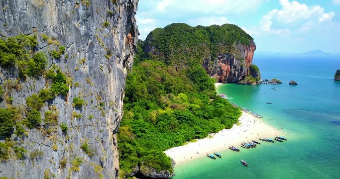 Aerial Overhead View of Boats on Tropical Island Beach Surrounded by Rocky Cliffs And Lush Greenery - Phra Nang Bay, Thailand