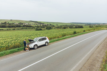 aerial view of broken car at roadside in the middle of nowhere