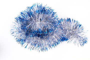Metallic and blue tinsel, white background. New Year and Christmas silver sparkling garland isolated on white background.