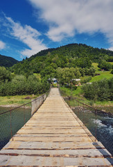 Suspension bridge over river.