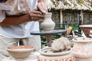 Human hands make a clay jug close-up. Sculptor's workshop. The sculptor makes a jug of clay close-up.