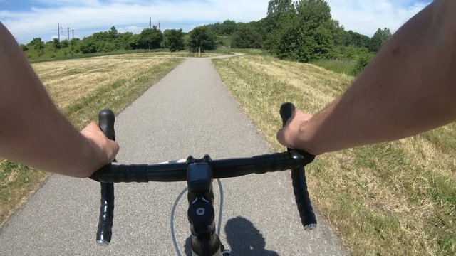Reaching forked road on racing bicycle in summer time