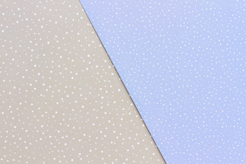 Delicate blue and gray paper patterned background. Beautiful paper with a pattern of snow for winter handmade decorations. New Year handmade ornaments material.