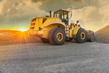 Moving gravel to fill the slope of a road