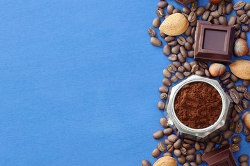 Blue background with coffee, chocolate, nuts