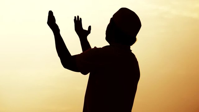 Close-up: Muslim men are praying for blessings from God footage slow motion