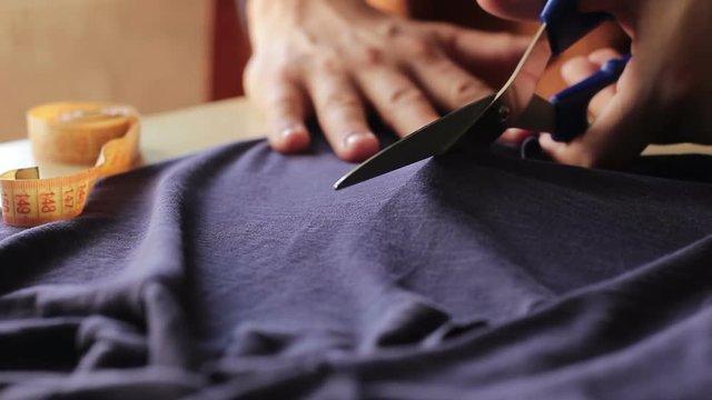 Dressmaker cutting fabric, close-up