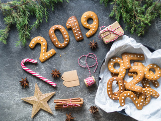 Ginger Christmas or New Year cookies in the form of numbers 2019 on a dark background .Seasonal packaging and New Year's attributes.
