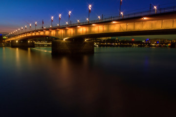 night view of the bridge from the river, Cologne city, Germany, on the banks of the River Rhine.
