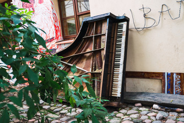 Broken piano lying on street
