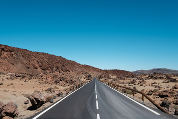 straight highway road through desert, mountain landscape