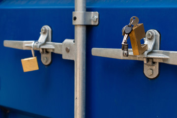 Unlocked clasp and padlock on a storage container.