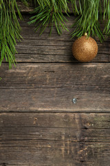 Yellow Christmas ball on wooden background
