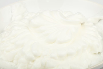 Fototapeta na wymiar Close up fresh whipped cream in white bowl