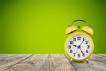 Retro alarm clock on table  background