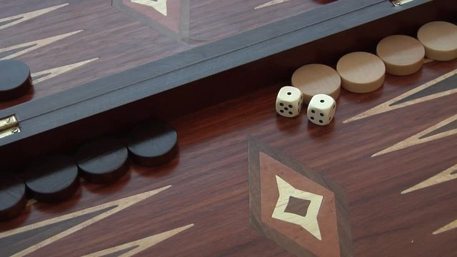 Rolling two dice on a Backgammon setting, the dice coming up as pair of 1. Set of four different rolls.
