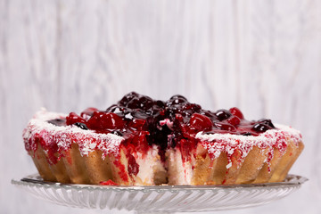 Sweet cake with cherry jelly, tasty and fresh on a white shabby wooden background