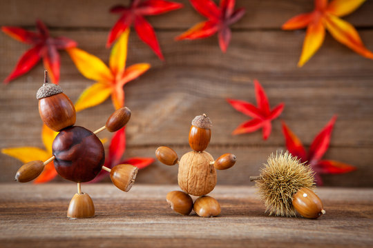 autumn tinker figures on wooden background