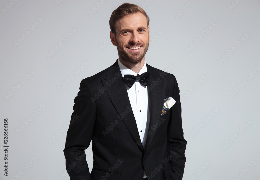 Poster portrait of a relaxed laughing young elegant man in tuxedo