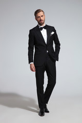 young elegant groom in tuxedo and bowtie