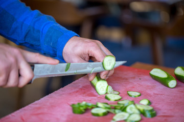 young male cook preparing breakfast in the restaurant.
