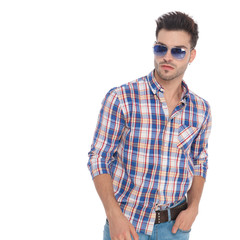 portrait of relaxed young man with sunglasses looks to side