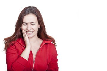 brunette woman holds her hand to her mouth due to painful toothache. she has closed eyes and makes a painful gesture. isolated on white background with textarea on the right for your message