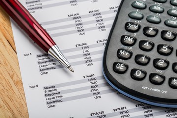 Calculator and Pen on Financial Figures