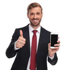 portrait of businessman making ok sign and showing phone screen