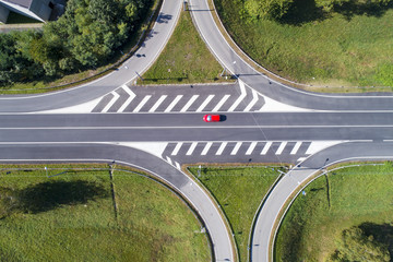 Road crossing and red car seen from above - 226570182