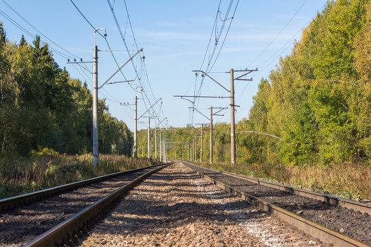 Double-track electrified railway on a sunny autumn day