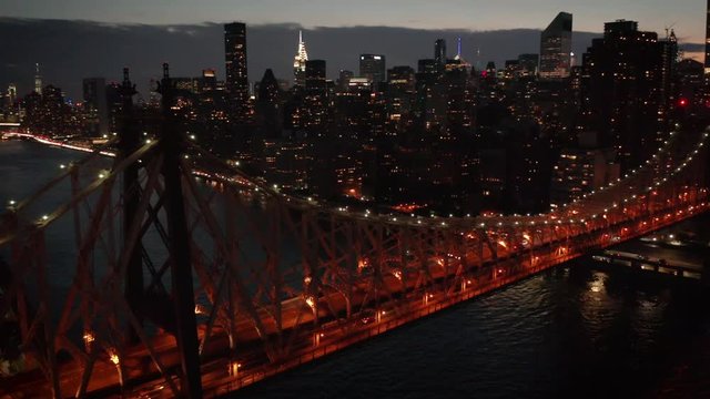 dusk orbiting Queensboro Bridge from NYC to LIC