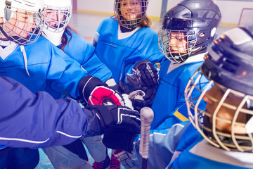 Ice hockey players putting their hands together