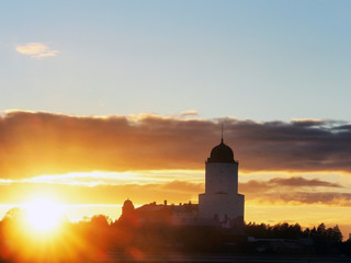 Saint Olav tower, medieval Swedish fortress castle on the sunset background in Vyborg, Russia. Rays of the autumn sunset sun, sun glare